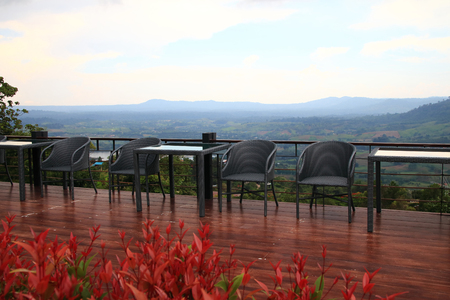 chair retro  and red flower in restaurant on fog and green hill background outdoor.の写真素材