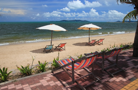 white umbrella  and colorful chair is relax vacation on the beach blue sky landscape background.の写真素材