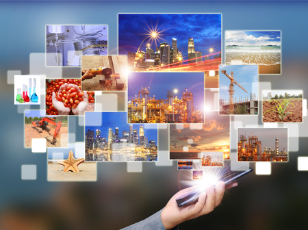 Phone communication with industrial image. Social media connecting images to food industry , petrochemical business, building and nature.の写真素材