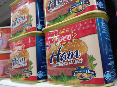 Highway Ham luncheon meat cans are being sold in the supermarket in Singaporeのeditorial素材