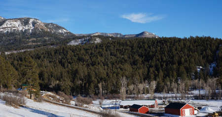 Red house under the snow mountain in the winter