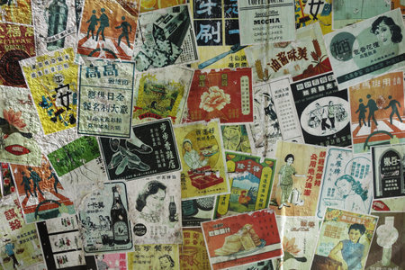 HONG KONG - NOV 21: Vintage advertisement papers paste on the wall on November 21, 2014 in Hong Kong, China. Hong Kong used to have a lot of paper pasted on the wall to advertise the products.のeditorial素材
