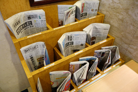 KYOTO, JAPAN - DEC 9: Various of newspapers located in the rack in Kyoto on December 09, 2014. Japanese newspapers run the gamut from general news-oriented papers to special interest newspapersのeditorial素材