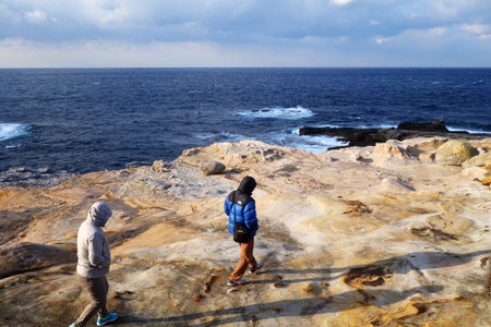 SHIRAHAMA, JAPAN - DEC 13: Tourists visit Sandanbeki in Shirahama on December 13, 2014. Sandanbeki Cliff has been created by the erosion of its waves.のeditorial素材