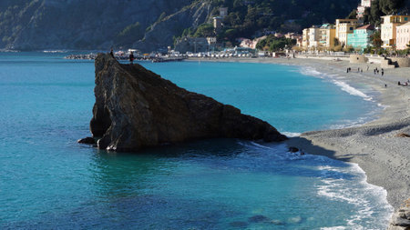 MONTEROSSO, ITALY- JAN 17: Tourists visit beach in Monterosso, Italy on January 17, 2015.The beach at Monterosso runs along most of the coast line and is well used by tourists and locals.のeditorial素材