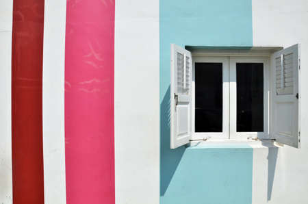 Wooden white windows on multi color wallの写真素材