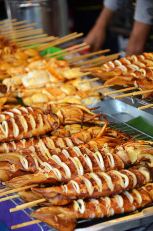Grilled squids on stick, Thai street food.の写真素材