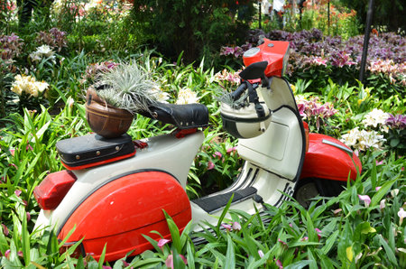 SINGAPORE- 10 july, 2016:  Red and white Vespa Italian designed scooter is parking in Gardens by the Bay, Singapore.のeditorial素材