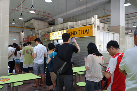 SINGAPORE - 30 JULY, 2016: Amoy street food centre, hawker centre with people having their meals or waiting for food in the morningのeditorial素材