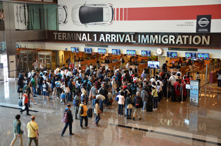 SINGAPORE - 18 NOV, 2016: Travelers enter immigration control at Changi International Airport in Singapore.のeditorial素材