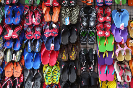 PATTAYA, THAILAND - 22 NOV, 2016: Colorful slippers hang on the road side for sale in Pattaya, Thailandのeditorial素材