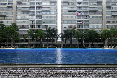 SINGAPORE - JAN 25,2017: Typical Singapore high rise housing estate with big swimming pool.のeditorial素材
