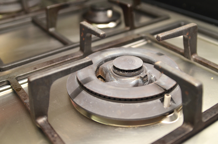Fragment of a used gas kitchen stoveの写真素材