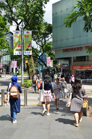 SINGAPORE- MAY 01, 2017: Shoppers and tourists walk along Orchard Road. The area is the prime shopping and entertainment district of Singapore.のeditorial素材