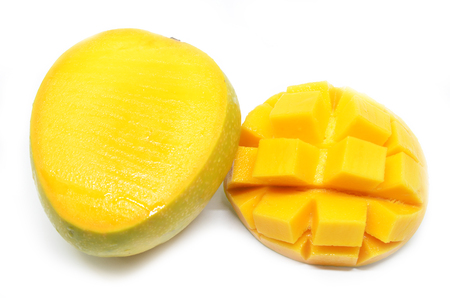 Mango cubes slices close up with mangos in white backgroundの写真素材
