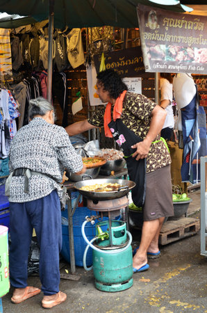 BANGKOK, THAILAND- MAY 19, 2017: Vendor sells street food to customers at Chatuchak weekend market. It is one of the largest market in Asia.のeditorial素材