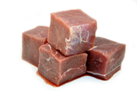 Diced or cubed raw beef steak isolated on white backgroundの写真素材