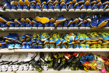 SINGAPORE- NOV 11, 2017: Rows of stylish man shoes on a rack for sale at a clothing store in Singapore.のeditorial素材
