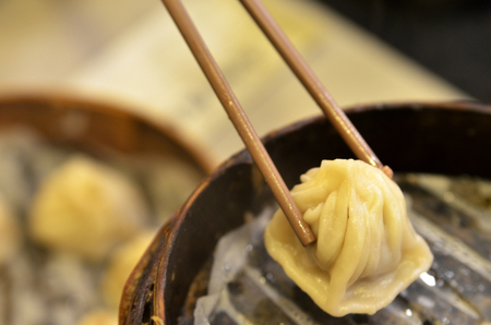 Traditional soup dumpling Xiao Long Bao is a popular Shanghai Chinese dim sum steamed in bamboo steamers.の写真素材