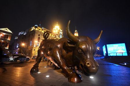 SHANGHAI CHINA - JAN 15, 2018: Charging Bull statue by Arturo Di Modica on The Bund in Shanghai, Chinaのeditorial素材