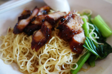 Popular Singapore Chinese street food, wantan mee, kind of noodles serve with bbq porkの写真素材