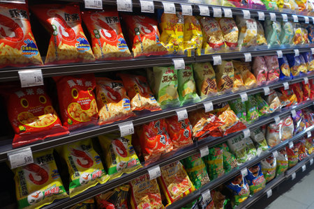 SHANGHAI, CHINA- JAN 22, 2018: Various brand of potato chips and snacks in packaging for sale on supermarket stand or shelfのeditorial素材