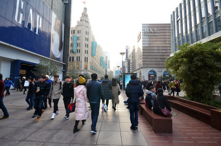 SHANGHAI, CHINA- DEC 26, 2017: On Nanjing Road Pedestrian Street - Modern buildings in western architectural designs line the metropolitan area. People walking on street.のeditorial素材