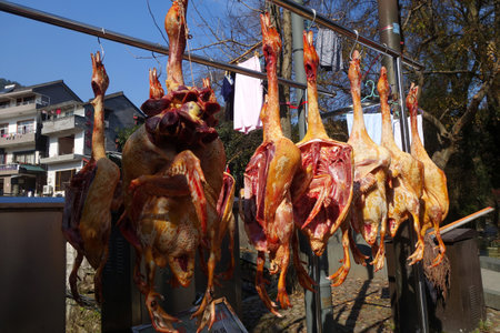 HANGZHOU, CHINA - DEC 26, 2017: Rows of cured meat hanging to dry in a rural market in Chinaのeditorial素材