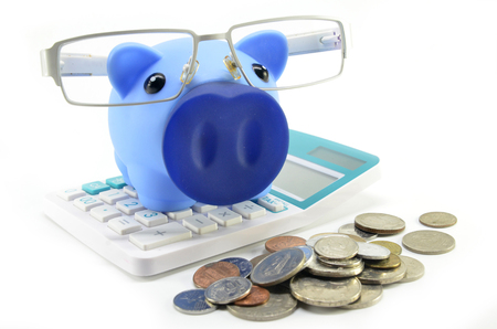 Blue piggybank with coins on a white backgroundの写真素材