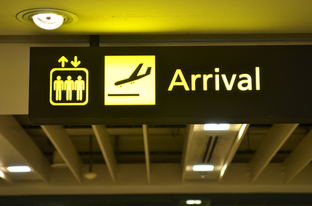 Airport arrival sign hanging from airport ceilingの写真素材