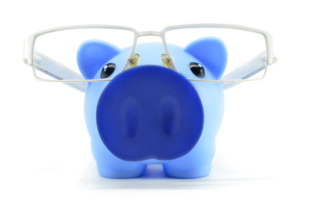 Blue piggy bank with glasses isolated on a whiteの写真素材
