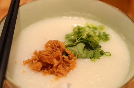 Rice porridge or congee with spring onion  and corianderの写真素材