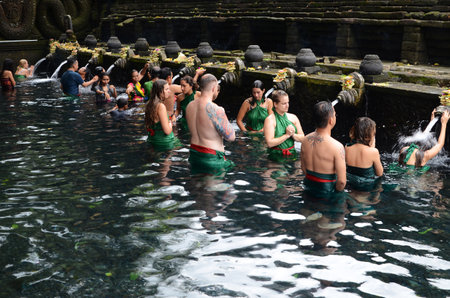 BALI, INDONESIA- 14 FEB, 2019: Worshippers pray in the water at the Tirta Empul Temple in Bali, Indonesiaのeditorial素材