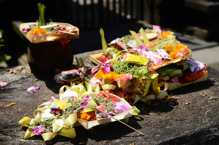 Traditional Balinese offerings to gods in Bali with flowers and aromatic sticksのeditorial素材