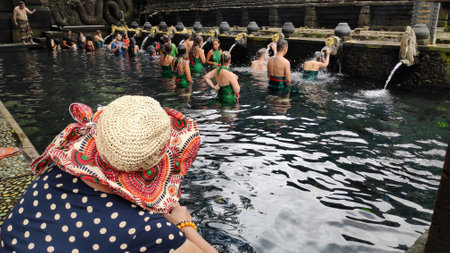 BALI, INDONESIA- 14 FEB, 2019: Worshippers pray in the water at the Tirta Empul Temple. It is believed that water from the spring is holy and has the healing power.のeditorial素材