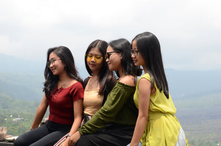 BALI, INDONESIA- 14 FEB, 2019: Beautiful young women with Mount Batur Volcano in Kintamani as background in Bali, Indonesia.のeditorial素材