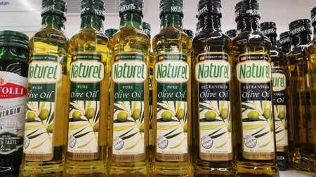 JOHOR BAHRU, MALAYSIA- MAY 20, 2019: Various bottles of olive oils sold at super market in Johor, Malaysia.のeditorial素材