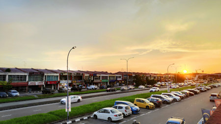JOHOR BAHRU, MALAYSIA- 25 MAY, 2019: Sunset over ordinary shop houses and car over Johor Bahru in Malaysiaのeditorial素材