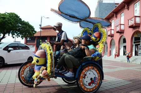MELAKA, MALAYSIA - 25 JUN, 2019: The decorated trishaw carry tourists to tour around in Dutch Square Malacca. Melaka has a historical site which was declared as the UNESCO world heritage in 2008のeditorial素材