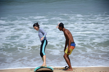Bali, Indonesia- 18 Oct, 2019: People learning surfing on the Balinese beach. Bali is the world...