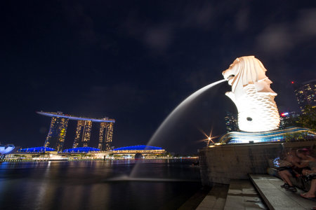 Singapore- Nov 16, 2019: Merlion statue fountain in Merlion Park and Singapore city skyline at night. Merlion fountain is one of the most famous tourist attraction in Singaporeのeditorial素材