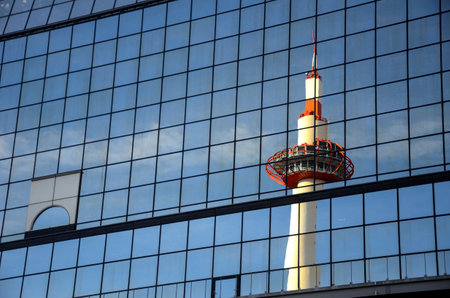 Kyoto, Japan- 24 Nov, 2019: Kyoto Tower mirrored by glass steel of Kyoto railway station Japan. The tower is the tallest structure in Kyoto with its observation deck at 100 metresのeditorial素材