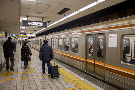 Osaka, Japan- 01 Dec, 2019: People wait at Osaka Subway station in Osaka Japan. Osaka Subway is 12th...