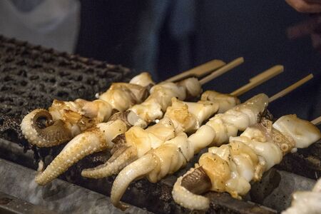 Vendor prepares seafood for sell in the Nishiki Market, Kyotoの写真素材