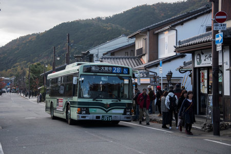 Kyoto, Japan-26 Nov, 2019: Kyoto city bus pass through Arashiyama street. The Kyoto City Buses are major mean of public transport in Kyotoのeditorial素材