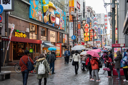 Osaka, Japan- 28 Nov, 2019: People visit Dotonbori street in Osaka during raining day. Dotonbori is the main entertainment area of Osaka.のeditorial素材