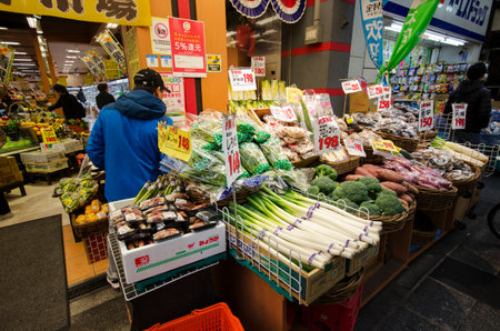 Osaka, Japan- 28 Nov, 2019: Small vegetable display with a variety affordable price front of retail store in Osaka fresh market.のeditorial素材