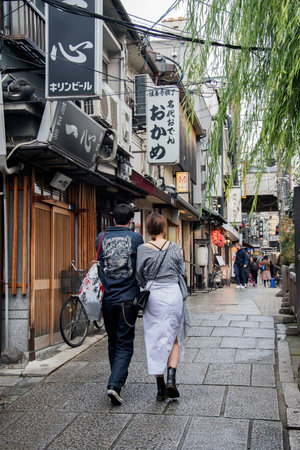Osaka, Japan- 28 Nov, 2019: People walk on Hozenji Yokocho in Osaka. Hozenji-yokocho Alley is stone-flagged streets and filled with over 60 tiny traditional restaurants and barsのeditorial素材
