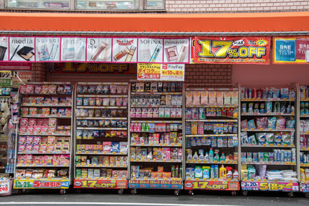 Osaka, Japan- 28 Nov, 2019: Colorful of sign and front of small Japanese cosmetic and pharmacy store with a lots of product and labels price, advertising words appealing to customers buy.のeditorial素材