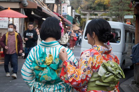 Kyoto, Japan- 25 Nov, 2019: Tourists wearing Japanese kimono walk toward Fushimi Inari in Kyoto.のeditorial素材